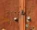 aged-wooden-doors-with-rivets-metal-lock_23-2148394622